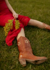 girl on grass in cowboy boots